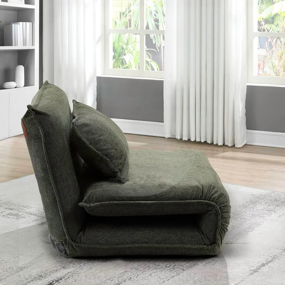 Winter moss fabric sofa bed in folded position near window on modern rug