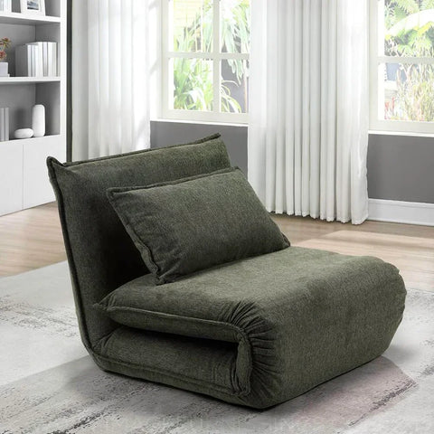 Corso sofa bed in winter moss fabric with cushion, shown in modern living room by window