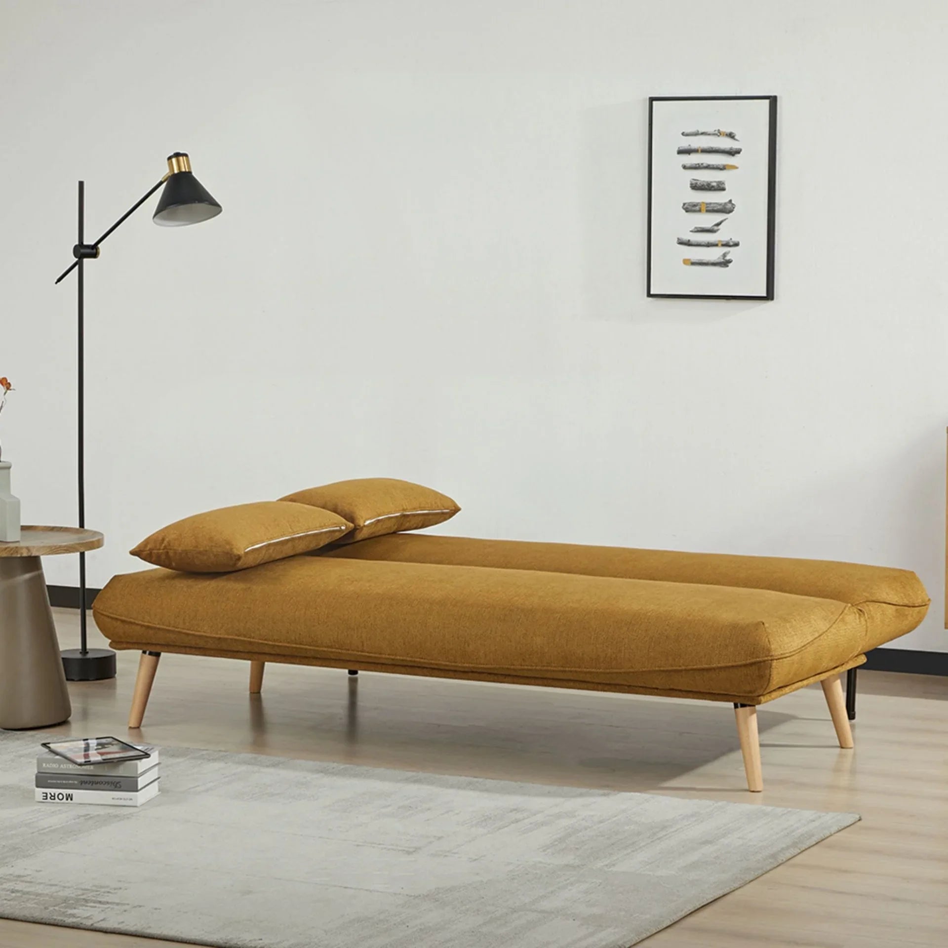 Pumpkin sofa bed with wooden legs in modern living room, set up as a bed with two cushions