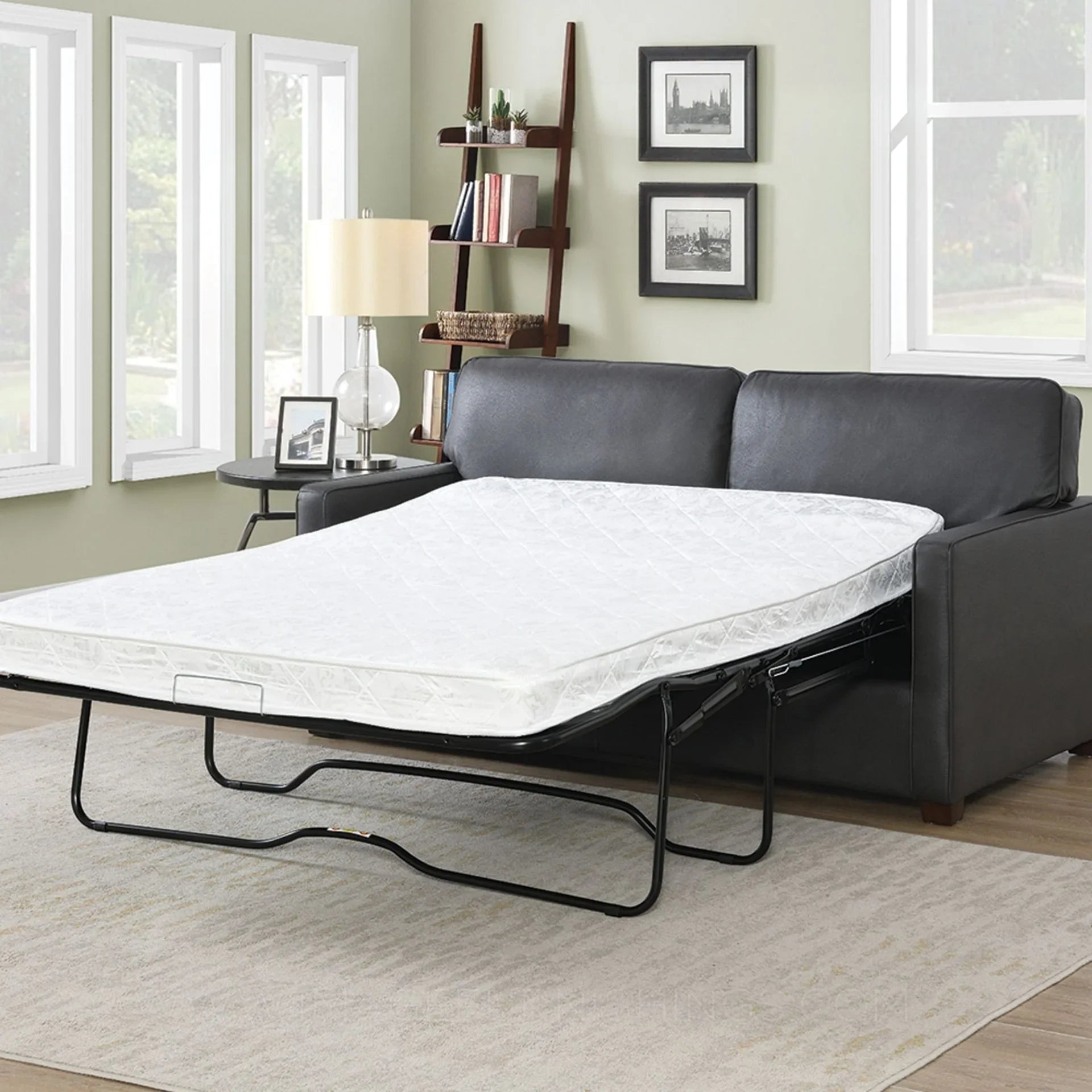 Grey sofa bed with mattress extended in modern living room setting
