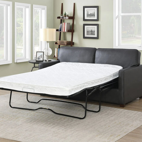 Grey sofa bed with mattress extended in modern living room setting