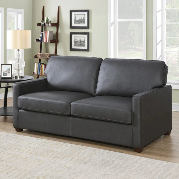 Grey sofa bed with straight arms and plush cushions in a bright living room