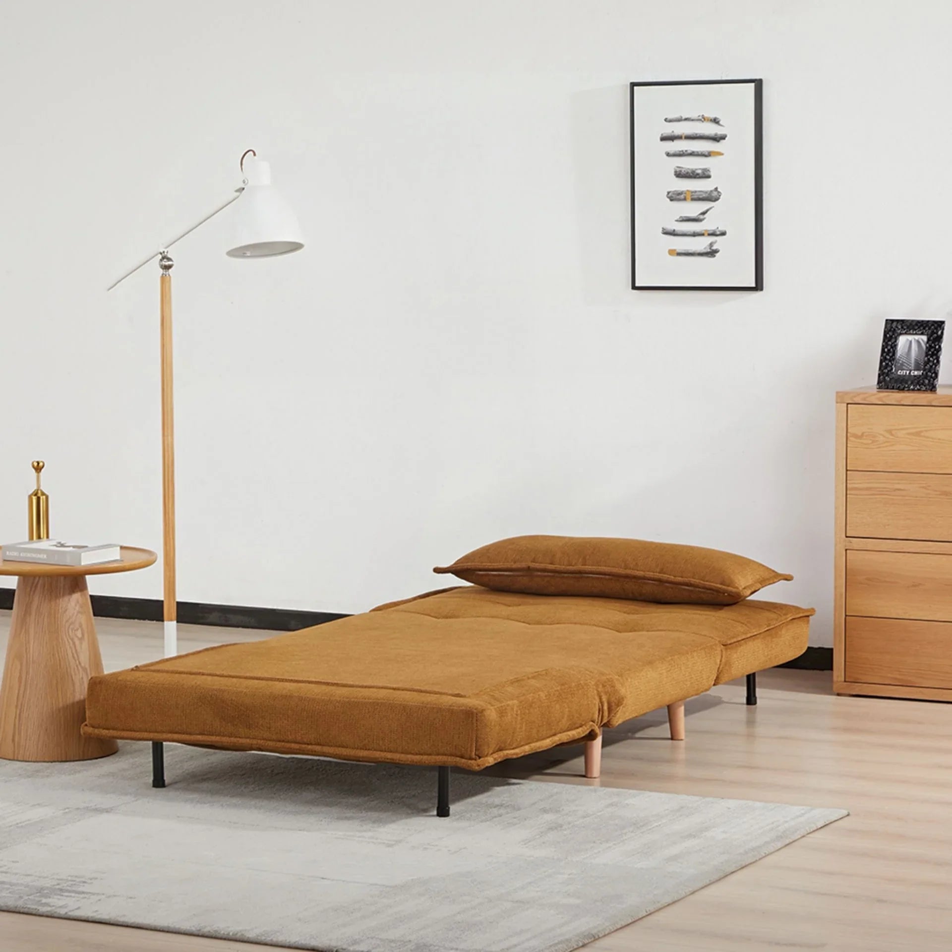 Pumpkin sofa bed in flat position with cushion in modern living room setting