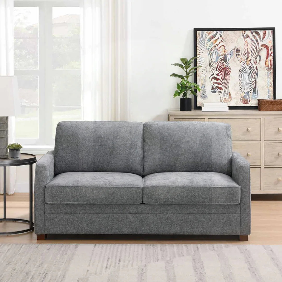 Grey foam sofa bed with two seat cushions in modern living room setting