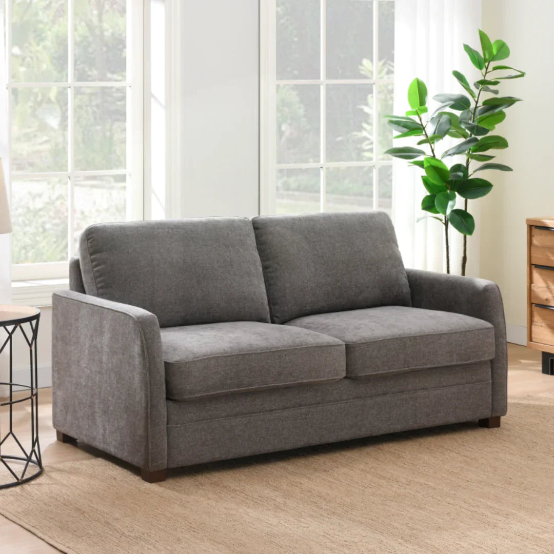 Stone full foam sofa bed with padded arms in bright living room setting