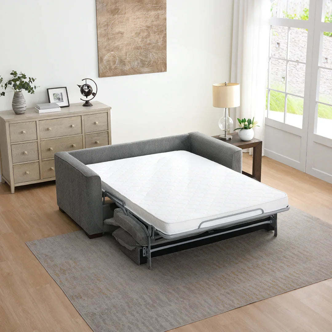 Light grey full foam sofa bed extended in modern living room with wooden furniture