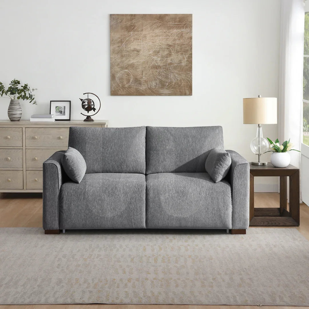 Light grey foam sofa bed with cushions in modern living room setting