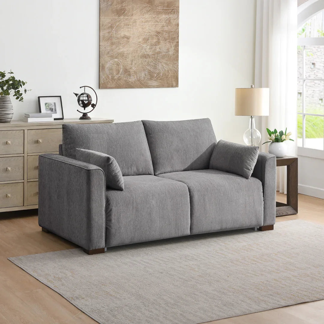 Light grey foam sofa bed with cushions in modern living room setting
