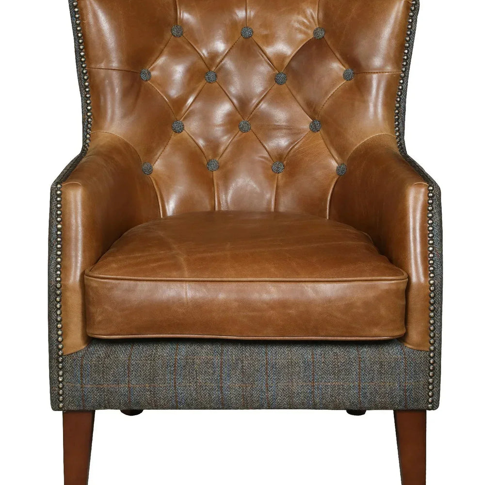 Brown leather accent chair with button-tufted back and tweed fabric base, front view