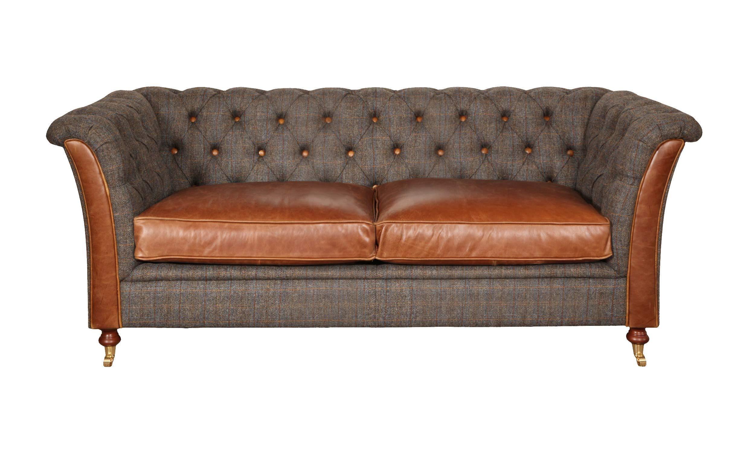 Brown leather and tweed fabric sofa with button back and wooden legs, front view