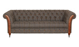 Brown tweed chesterfield sofa with button tufting and leather rolled arms on castor legs