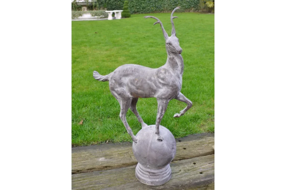 antelope statue garden ornament on stone base displayed on lawn