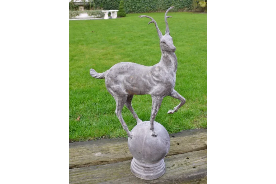 antelope statue garden ornament on stone base displayed on lawn