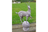 antelope statue garden ornament on stone base displayed on lawn