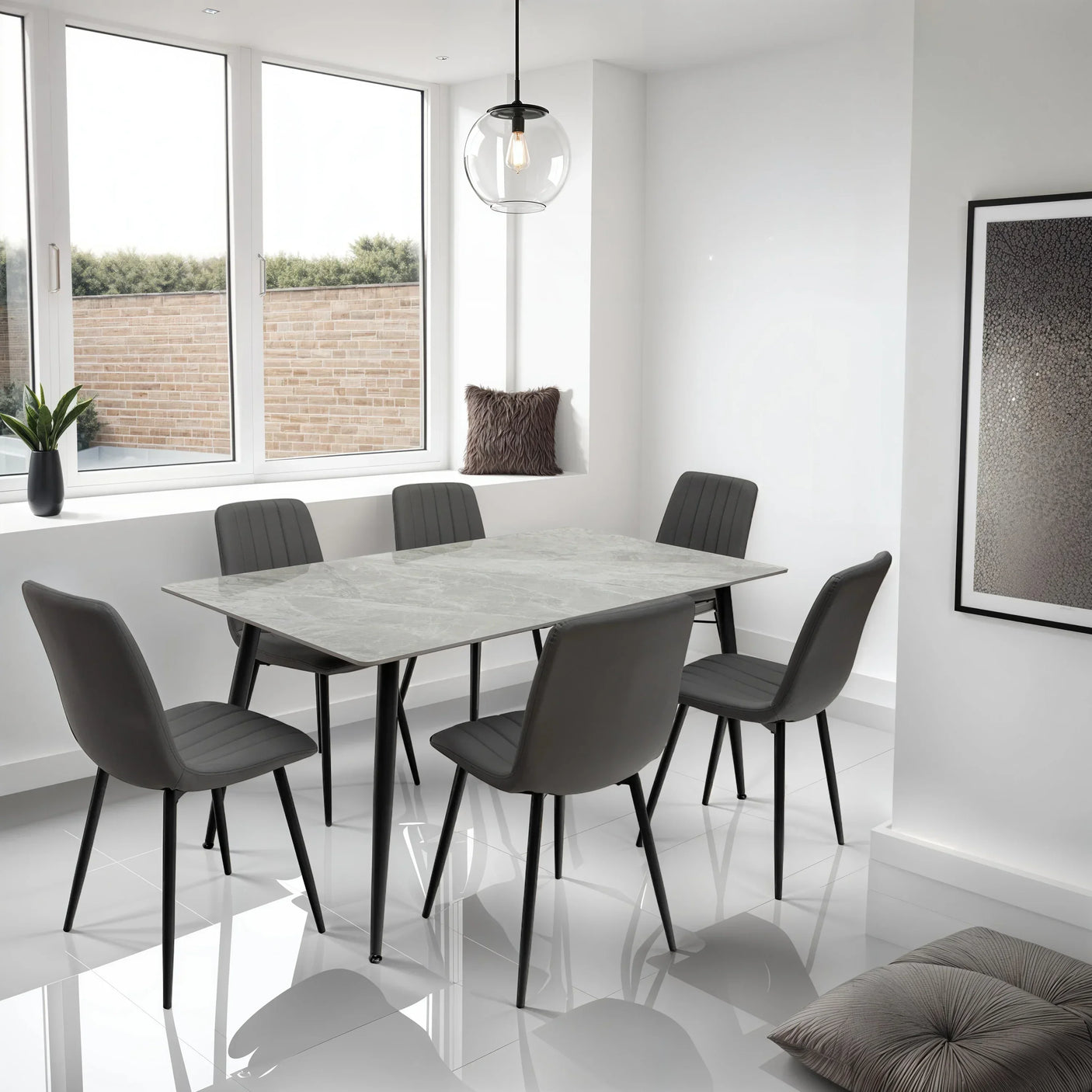 Grey dining table set with six padded chairs in modern kitchen with large windows