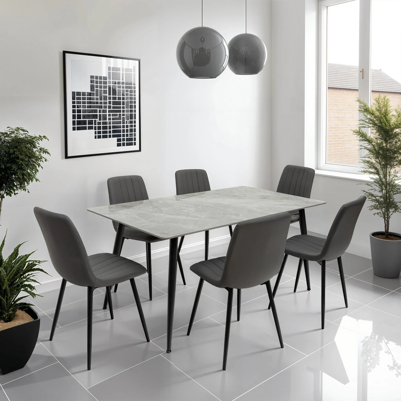 Grey marble dining table set with six modern chairs in a bright tiled dining room