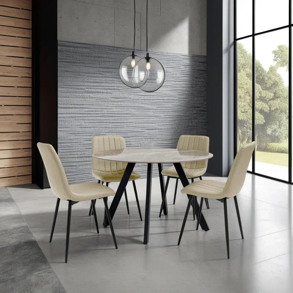 Round marble dining table with four cream upholstered chairs in modern dining room