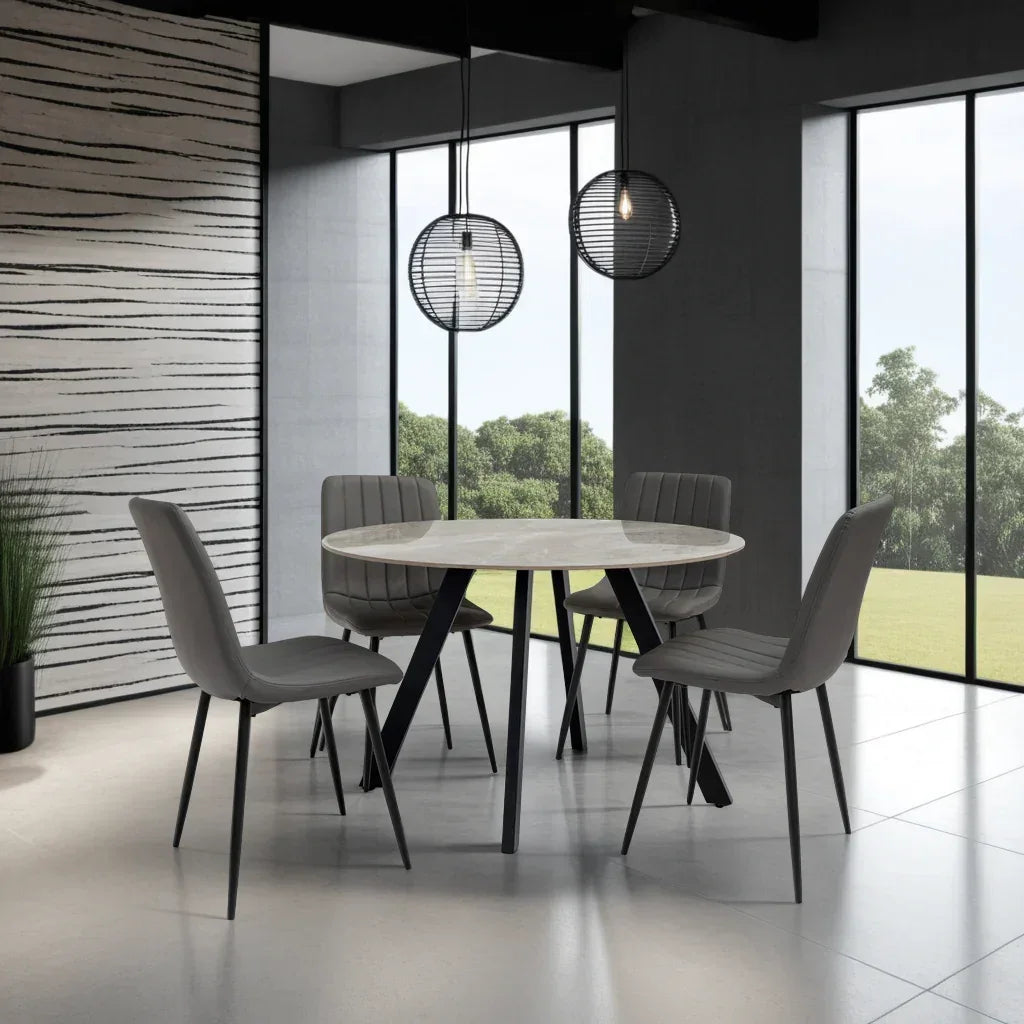 Round marble dining table with four grey upholstered chairs in modern dining room