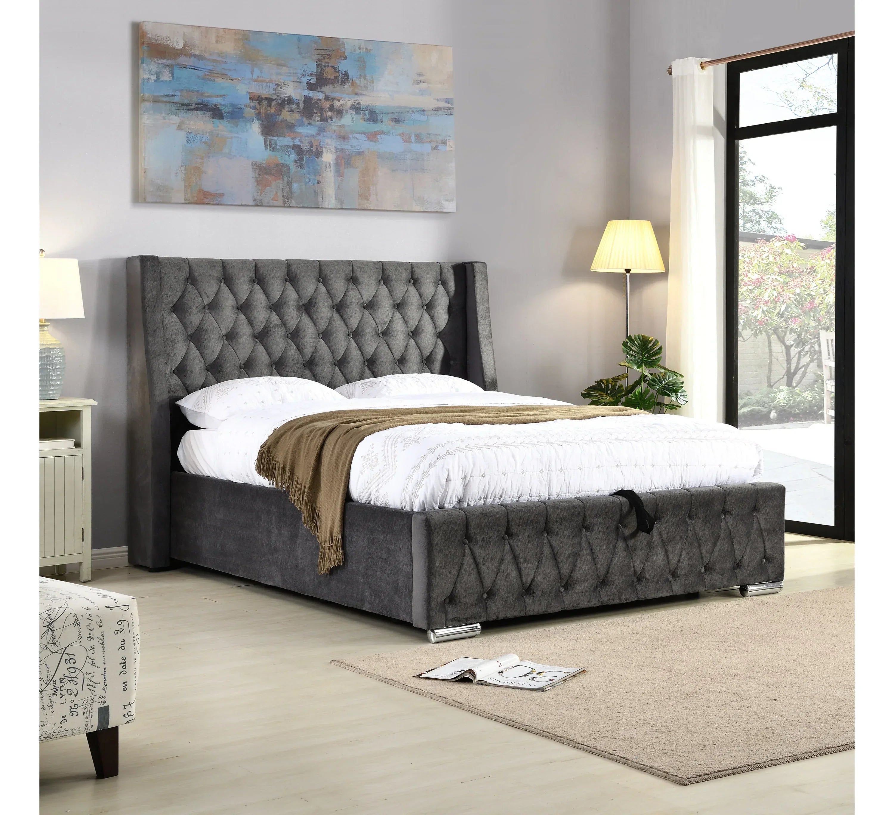 Grey upholstered bed with tufted headboard and footboard in modern bedroom setting
