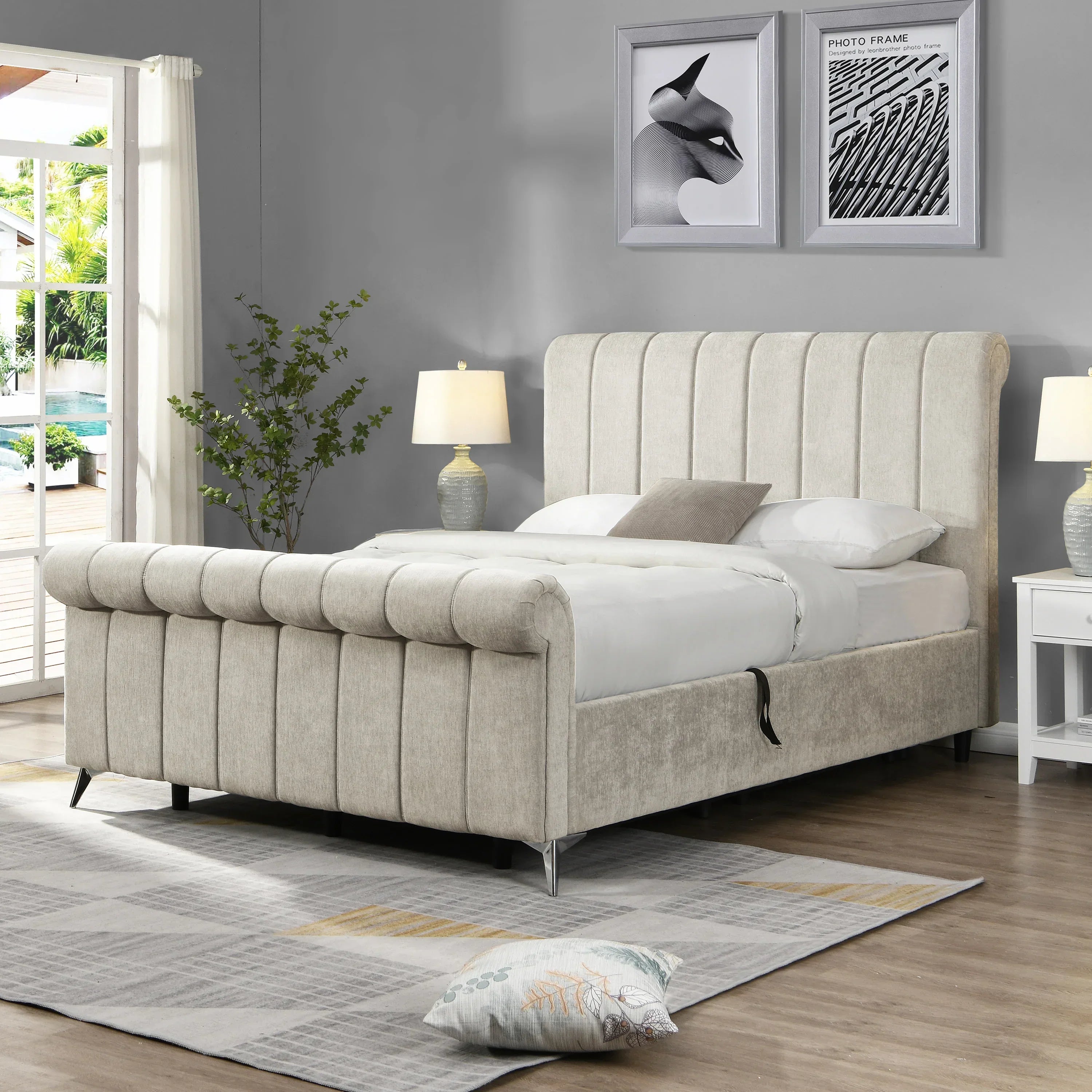 Beige upholstered bed frame with rolled headboard and footboard in modern bedroom