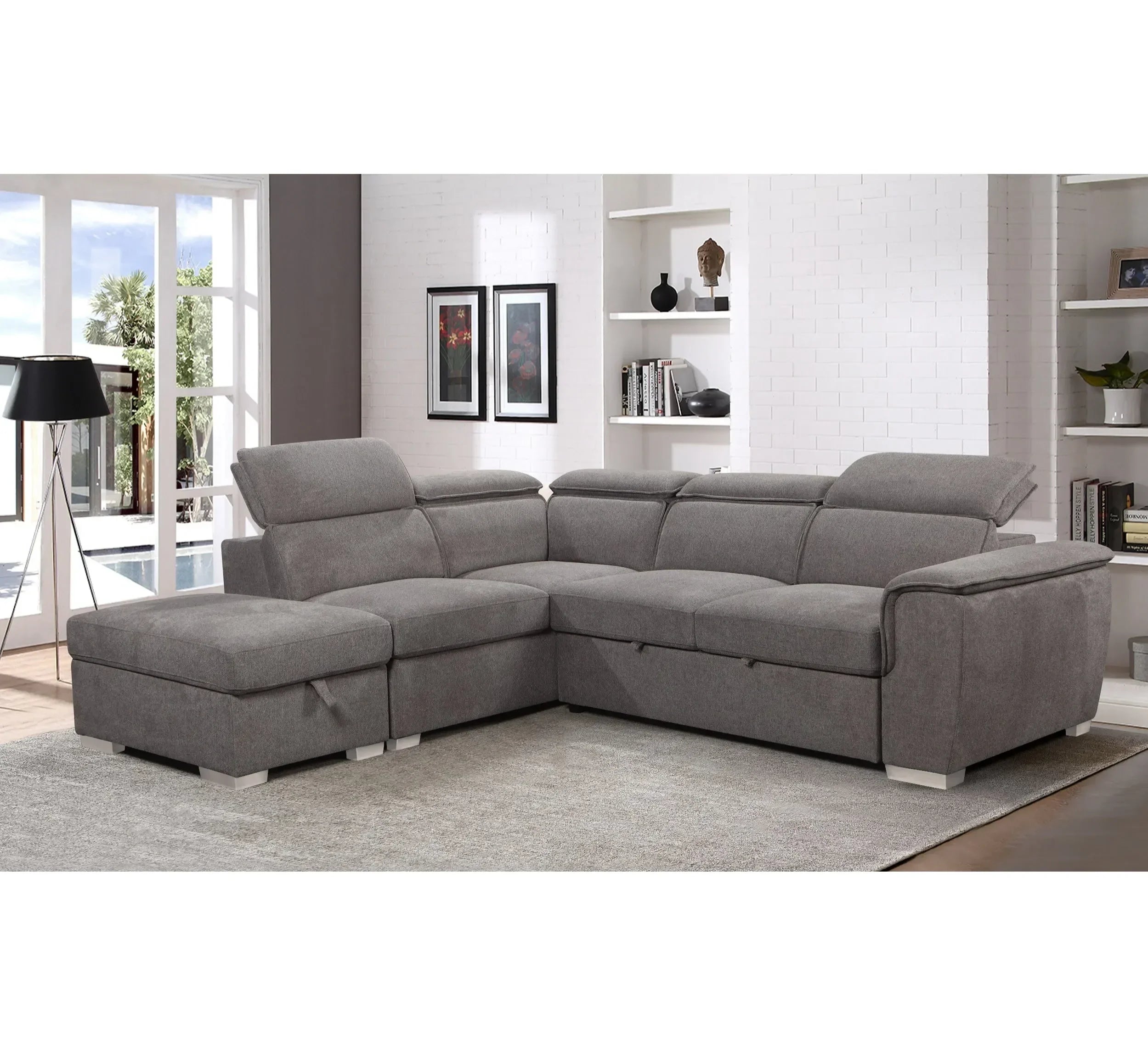 Grey corner sofa with adjustable headrests in modern living room on light carpet