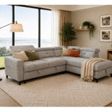 Grey corner sofa with plush cushions and a cozy throw, set in a bright living room with large windows