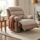 Reclining armchair in two-tone fabric with a cozy blanket draped over it in a bright living room setting