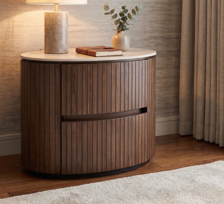 Cleo Locker with a round top, wooden slats, and a drawer, styled with a lamp and decor