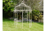 Cream metal garden gazebo with ornate scrollwork on lawn