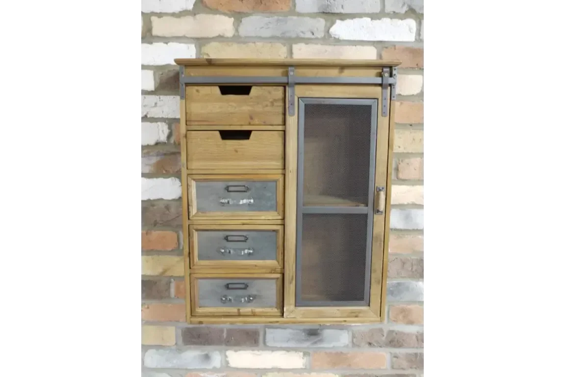 Industrial wood and metal wall cabinet with mesh door and storage drawers against brick wall