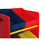 Three-tier kids storage unit featuring vibrant red, blue, and yellow colors. The unit has two red fabric bins and one blue fabric bin, all with cut-out handles for easy access. A yellow horizontal bar runs across the front, adding a playful touch to the design
