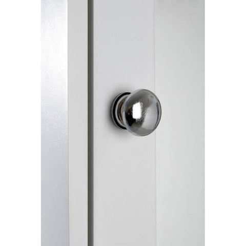 Close-up view of a sleek, modern cabinet featuring a mirrored surface and a round, metallic knob. The cabinet has a clean, minimalist design with a light-colored finish