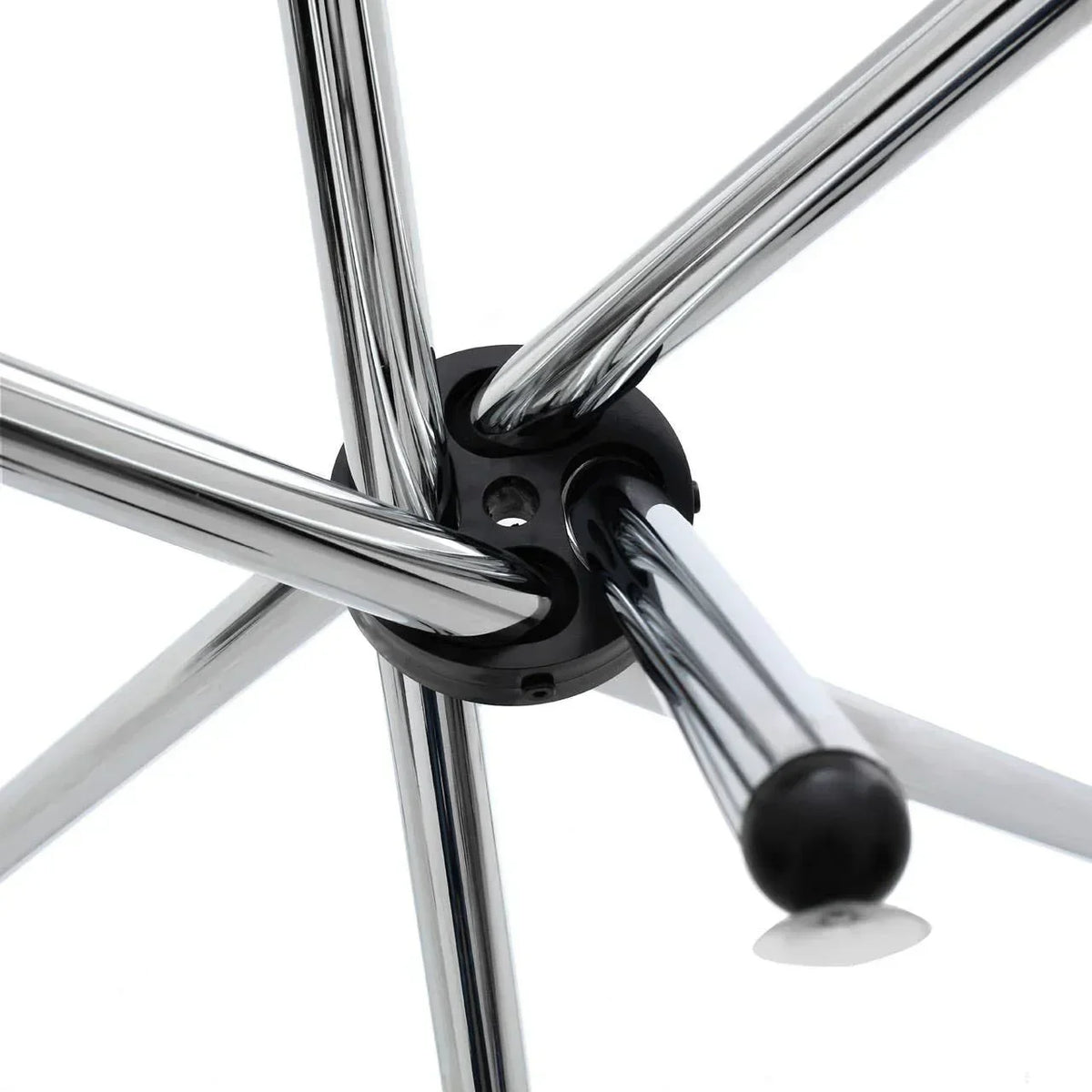 Closeup of chrome dining chair legs with black plastic floor protector detail