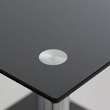 Black glass end table featuring a sleek two-tier design with a circular silver accent on the top surface. The table has a modern aesthetic, suitable for contemporary home decor