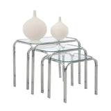 Glass nesting tables with chrome legs, decorative white vases on top