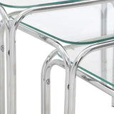 Closeup of glass nest of tables with chrome metal legs and clear tempered glass tops