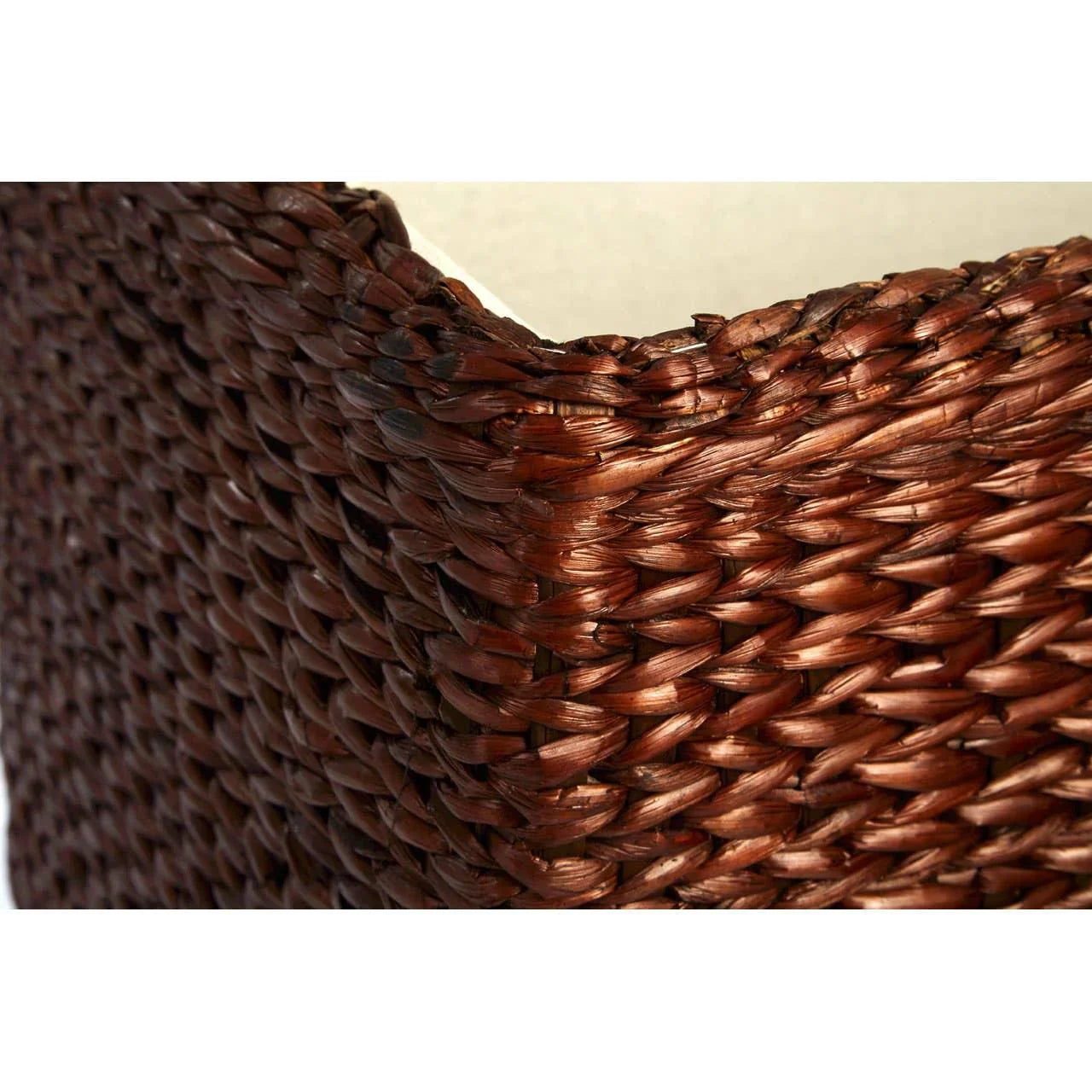 Close up of brown wicker furniture with woven rattan texture and curved edge