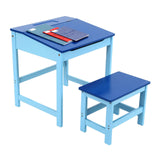 A blue children's desk with a matching stool, featuring a flat top with a red and white drawing pad and colored pencils on the desk surface. The desk has a simple design with straight legs, and the stool is smaller with a similar blue finish