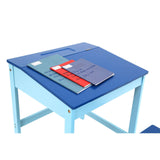 A blue children's desk with a smooth top, featuring a stack of colorful notebooks and a few loose sheets of paper on its surface. The desk has sturdy legs and a simple design, suitable for a child's room or study area
