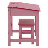 A pink children's desk with a slanted top and a matching pink stool, both featuring a simple design and sturdy construction. The desk has a small cutout on the top surface, and the stool is designed to fit neatly underneath the desk