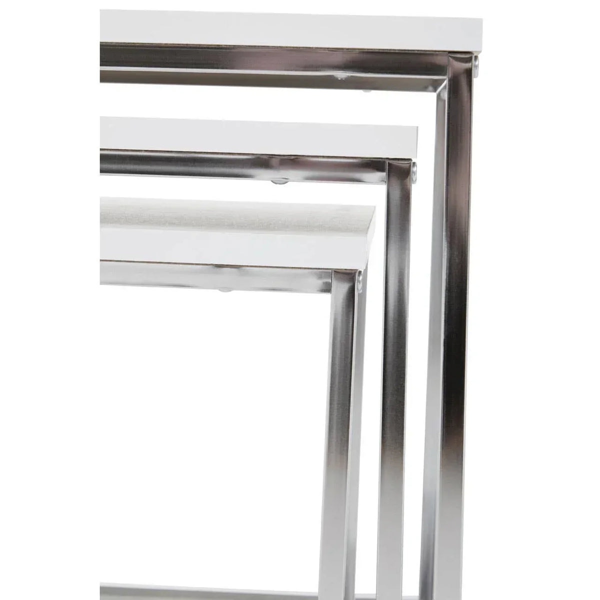 Modern nesting tables with white tops and chrome metal frames, close-up side angle
