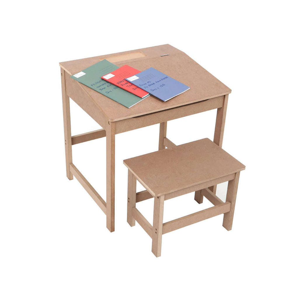 Natural wood desk with a slanted top and a matching stool, accompanied by three colorful notebooks in red, blue, and green placed on the desk surface. The furniture is designed for children, showcasing a simple and functional style