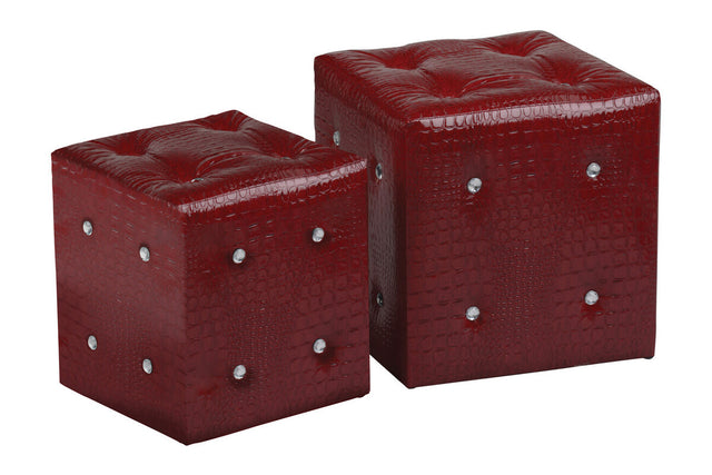 Two red stools with a crocodile leather effect, featuring a glossy finish and decorative silver studs on the sides. The stools are cube-shaped, with one being slightly larger than the other