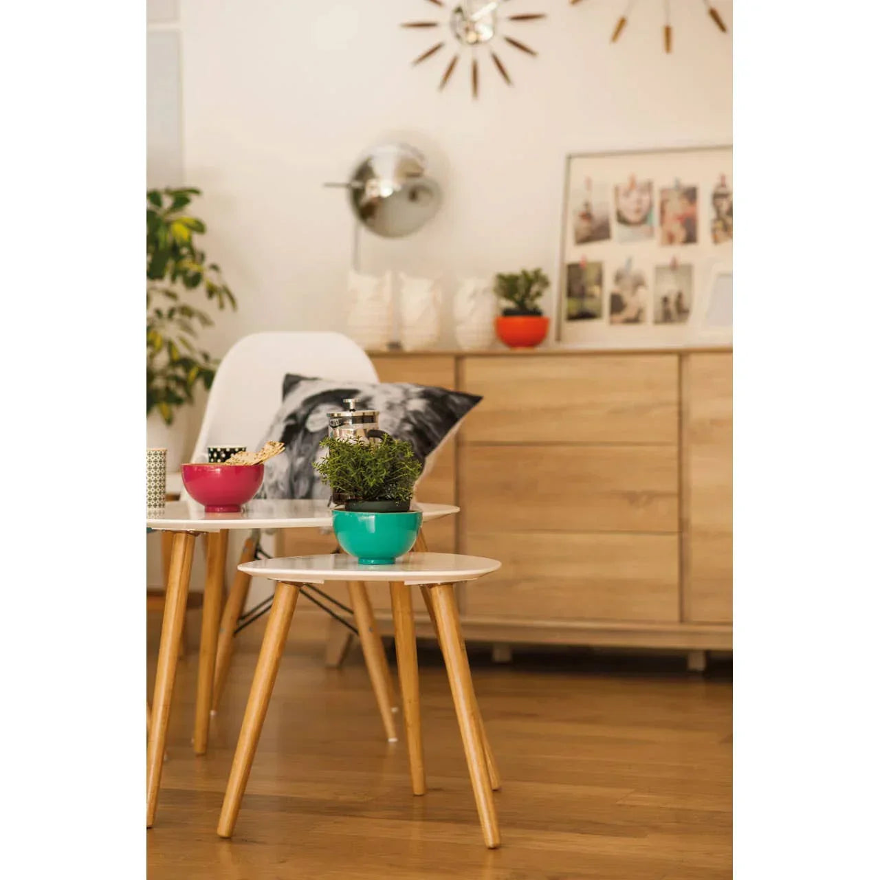Modern side tables with white tops and wood legs, styled with bowls and green plant