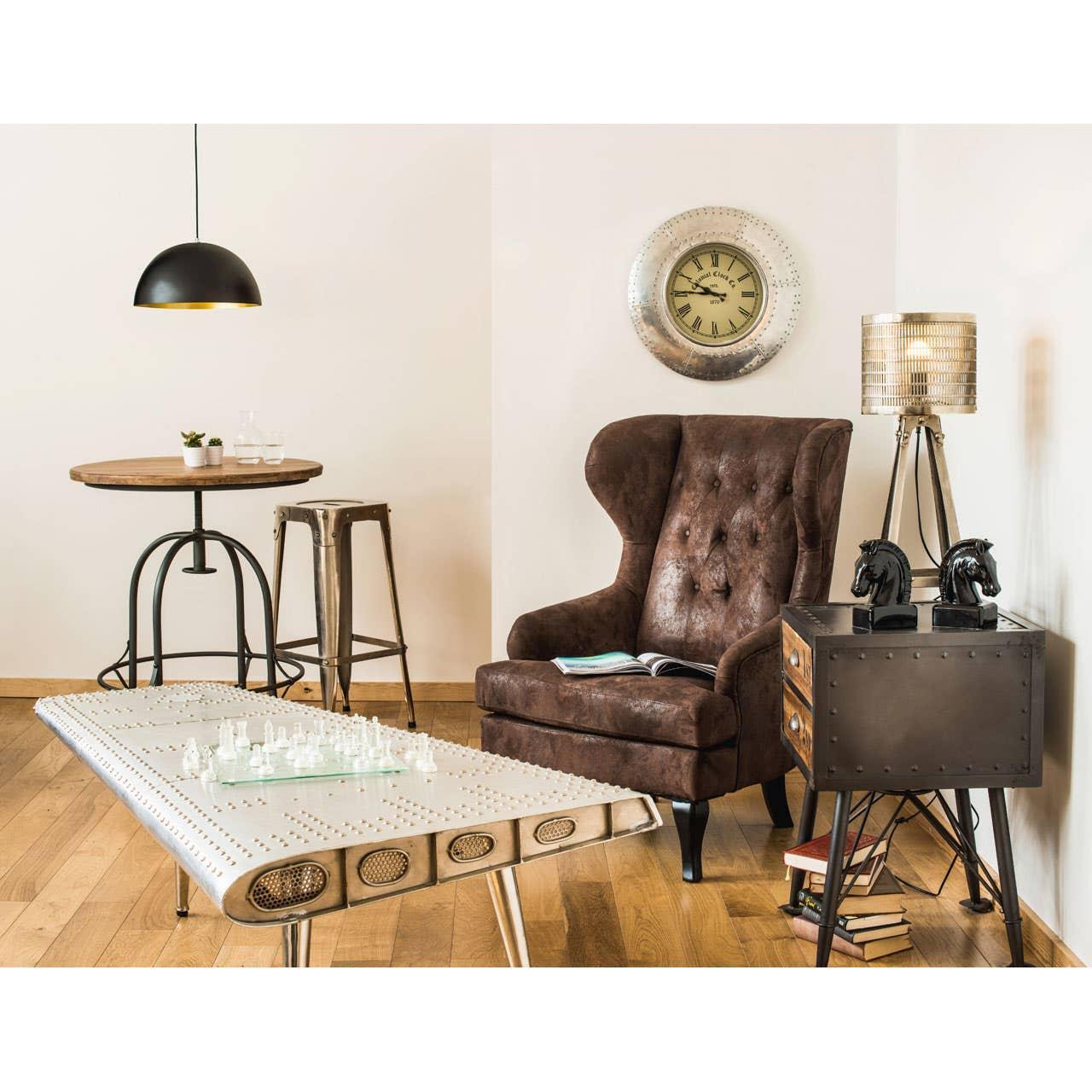 Brown wingback armchair with tufted back beside metal coffee table and sideboard in living room