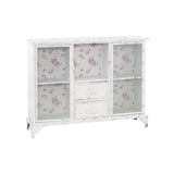 White cabinet featuring two doors and two drawers, with a floral pattern on the glass panels of the doors. The cabinet has a sleek design and stands on four legs, providing a modern touch to home decor