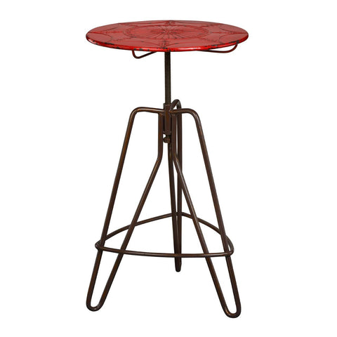 Round red metal bar table with a textured surface, supported by a sturdy brown metal base featuring a tripod design and adjustable height mechanism