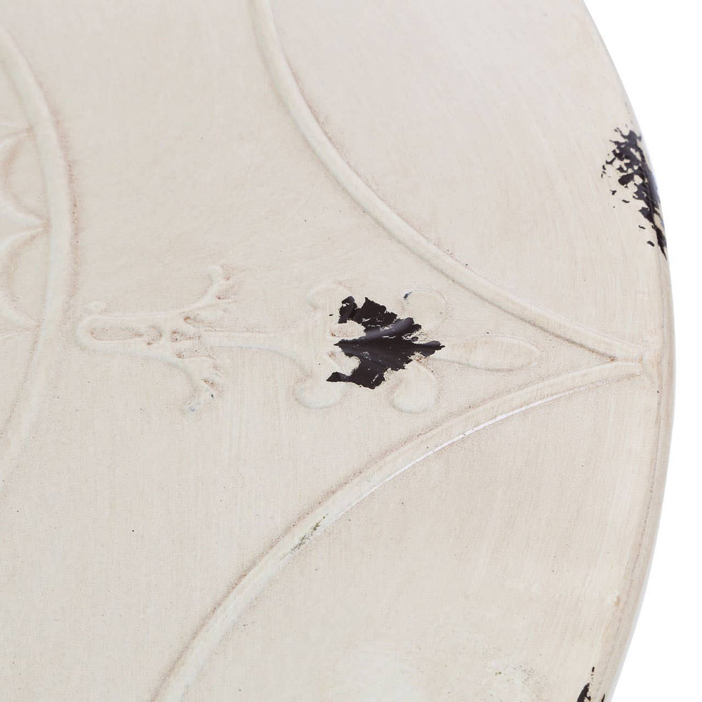 Cream-colored round metal bar table with a textured surface featuring subtle black accents and intricate detailing. The table has a sleek, modern design suitable for various home decor styles