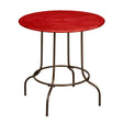 Round table with a vibrant red top and a sturdy metal base featuring four legs and a circular support structure. The design combines a modern aesthetic with a rustic touch, suitable for various home decor styles