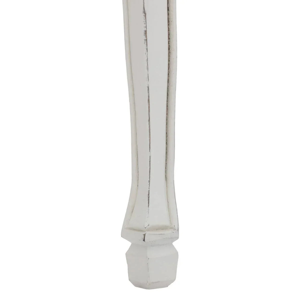 Distressed white wooden furniture leg with carved detailing close up